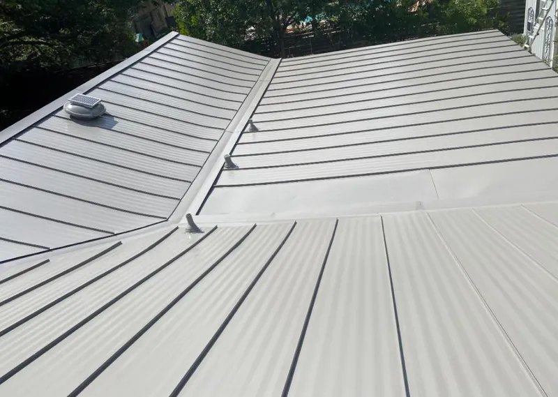 Solar attic fan installed on a metal roof for Roof Ventilation in Poteau